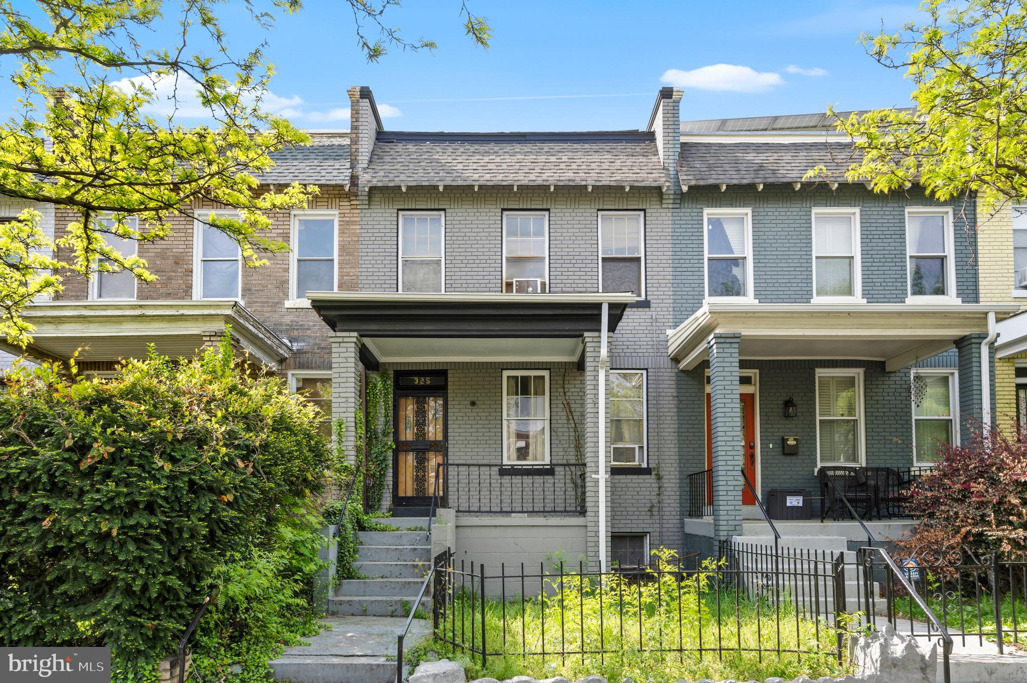 325 Bryant Street Northeast Washington, DC 20002 - Photo 1 of 28 a view of a brick house with large windows and a flower plants