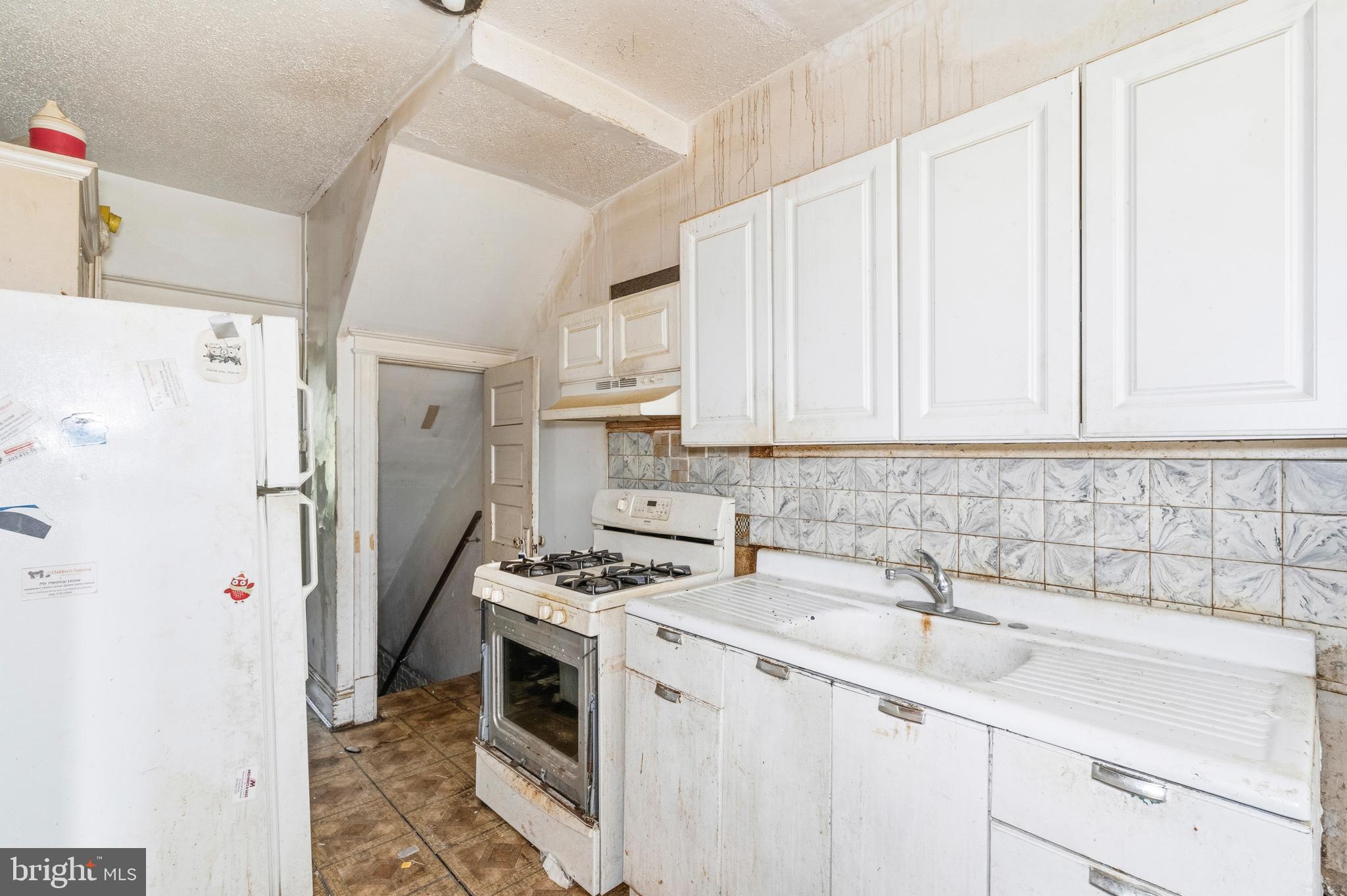 325 Bryant Street Northeast Washington, DC 20002 - Photo 6 of 28 a kitchen with appliances a sink and cabinets