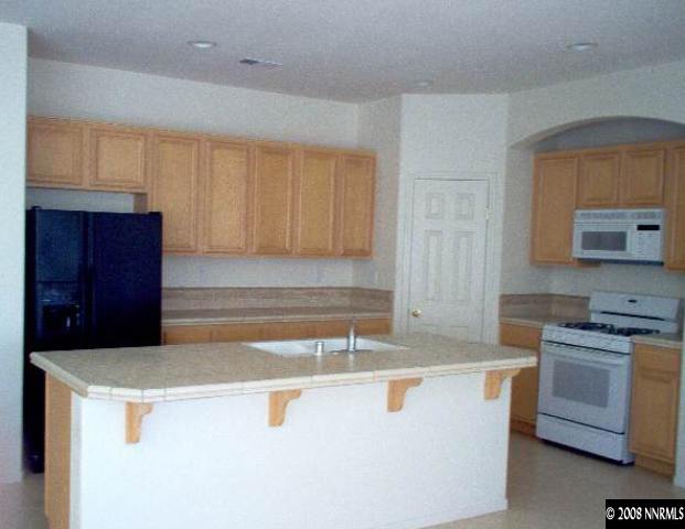 1420 Diamond Country Drive Reno, NV 89521 - Photo 2 of 4 a kitchen with a sink a stove and cabinets