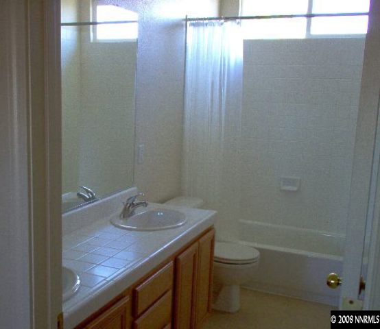 1420 Diamond Country Drive Reno, NV 89521 - Photo 4 of 4 a bathroom with a granite countertop sink toilet and shower