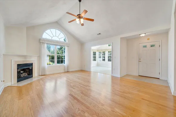 a view of a room with wooden floor and chairs