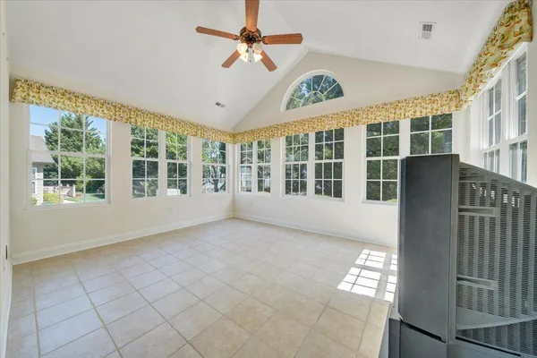 a room with table chairs and kitchen view