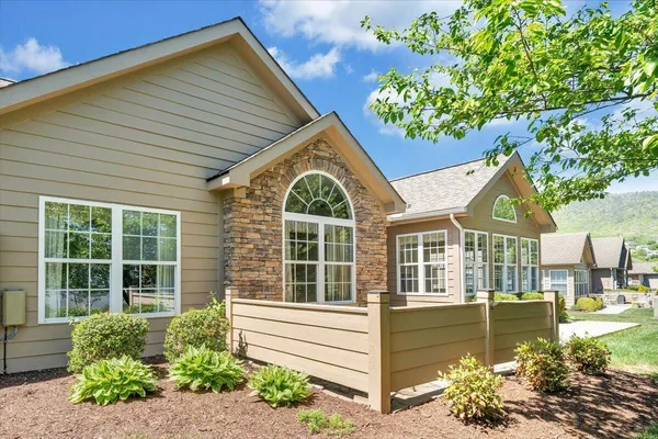a front view of a house with a garden