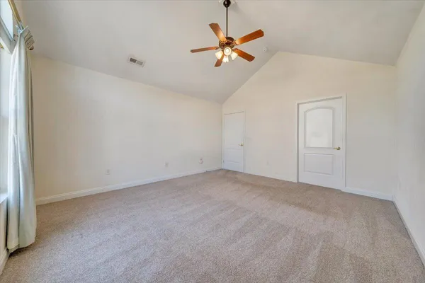 a kitchen with stainless steel appliances a white refrigerator a stove a sink and white cabinets with wooden floor