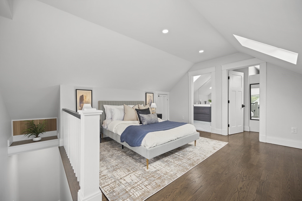 72 Governor Winthrop Road, Unit 2 Somerville, MA 02145 - Photo 11 of 27 a bedroom with a bed and a couch