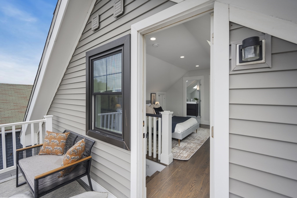 72 Governor Winthrop Road, Unit 2 Somerville, MA 02145 - Photo 13 of 27 a view of a porch with furniture and a window
