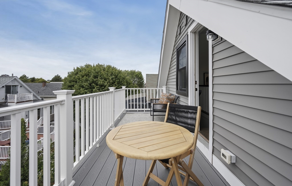 72 Governor Winthrop Road, Unit 2 Somerville, MA 02145 - Photo 14 of 27 a balcony view with a wooden floor