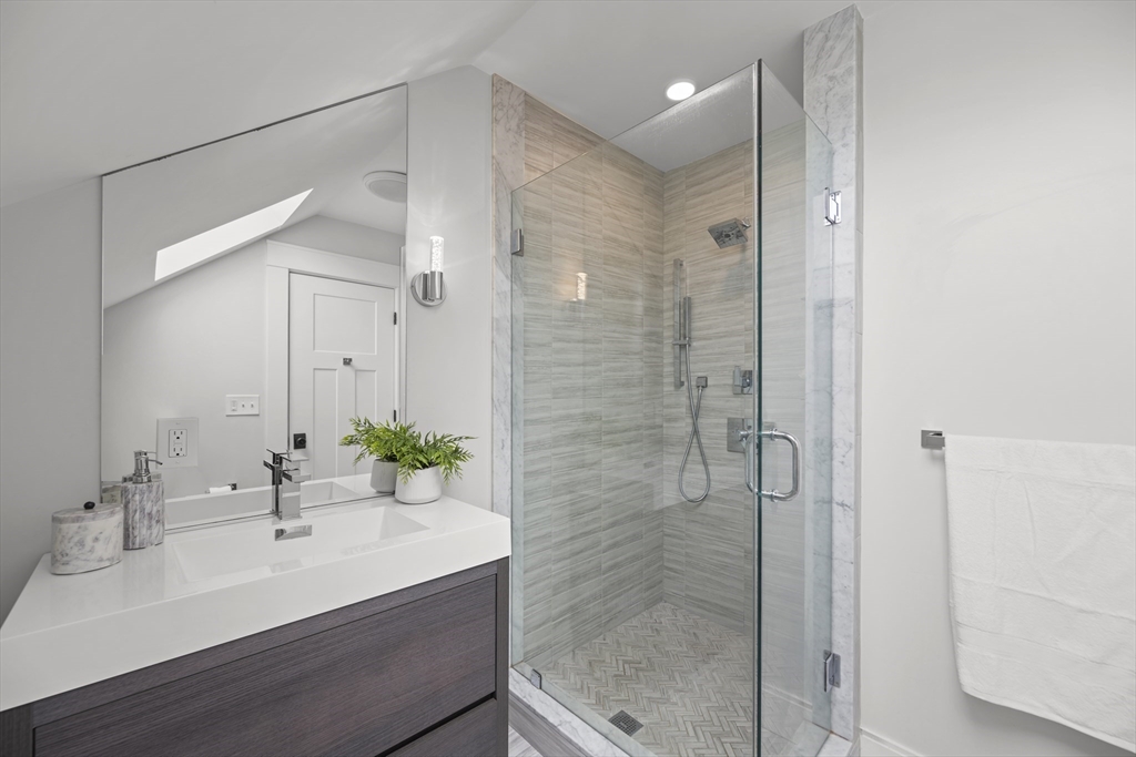 72 Governor Winthrop Road, Unit 2 Somerville, MA 02145 - Photo 15 of 27 a bathroom with a sink shower and a mirror