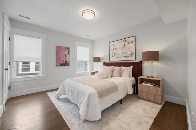 a bedroom with a bed and a night stand