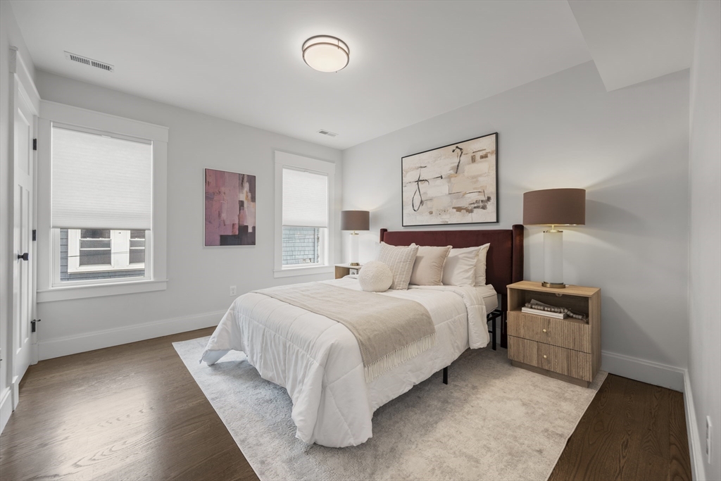 72 Governor Winthrop Road, Unit 2 Somerville, MA 02145 - Photo 17 of 27 a bedroom with a bed and a night stand