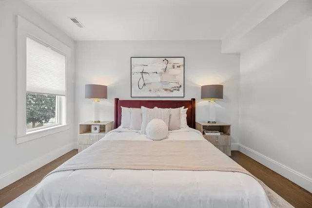 a bedroom with a large bed and a window