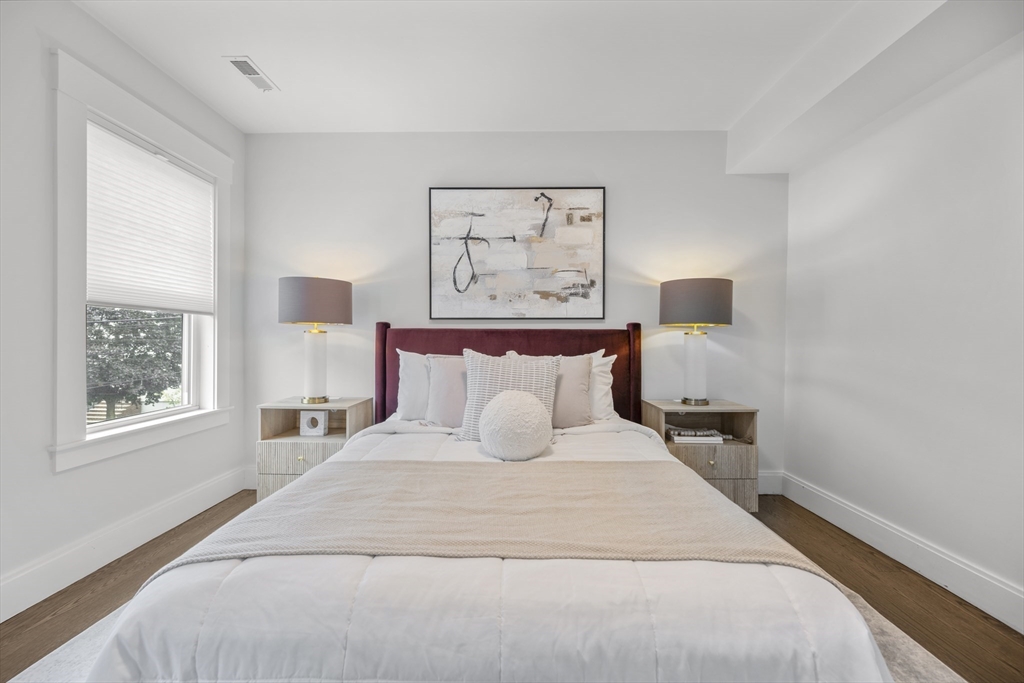 72 Governor Winthrop Road, Unit 2 Somerville, MA 02145 - Photo 18 of 27 a bedroom with a large bed and a window