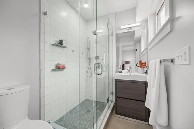 a bathroom with a shower and a sink