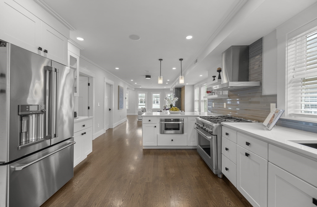 72 Governor Winthrop Road, Unit 2 Somerville, MA 02145 - Photo 2 of 27 a kitchen with white cabinets and stainless steel appliances