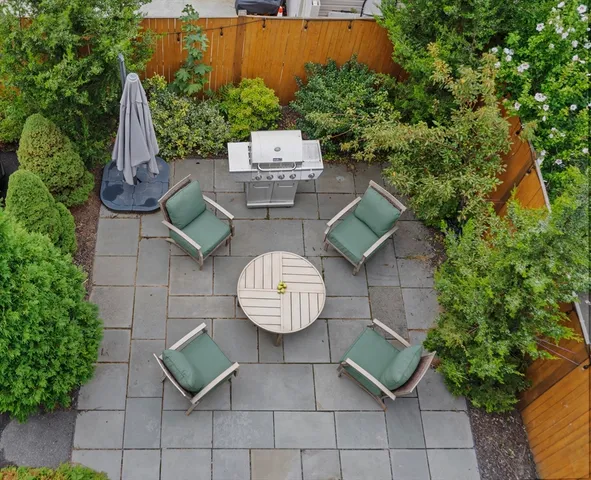 an aerial view of a chairs and table in wooden floor