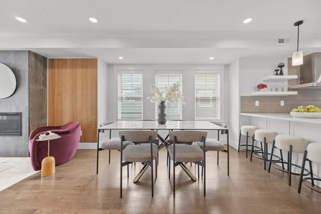 a dining room with furniture and wooden floor