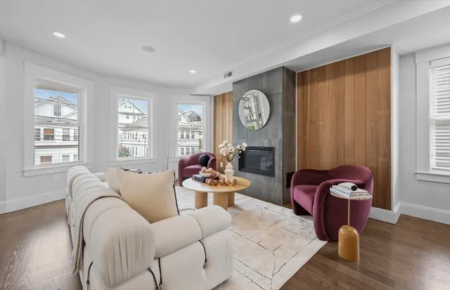 a living room with furniture and wooden floor
