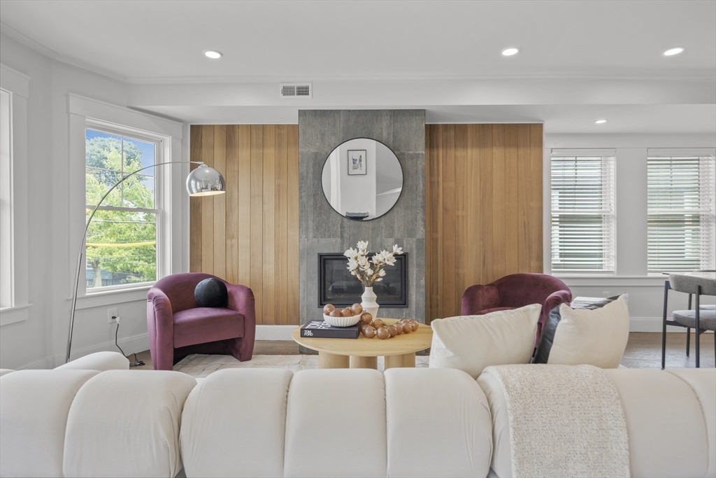 72 Governor Winthrop Road, Unit 2 Somerville, MA 02145 - Photo 8 of 27 a living room with furniture and a large window