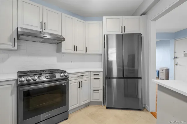 a kitchen with granite countertop stainless steel appliances and cabinets