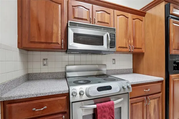 a kitchen with granite countertop cabinets stainless steel appliances and a sink