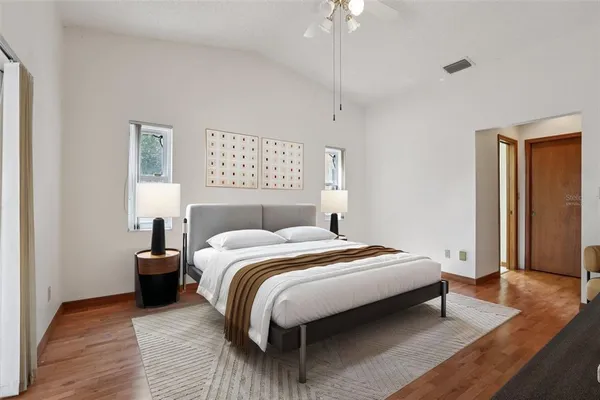 a bedroom with a bed and wooden floor