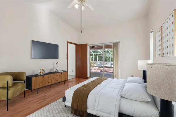 a bedroom with a bed and a flat screen tv