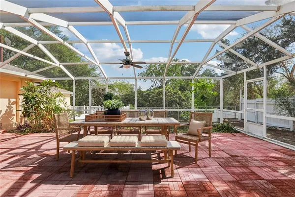 a view of a patio with table and chairs and potted plants