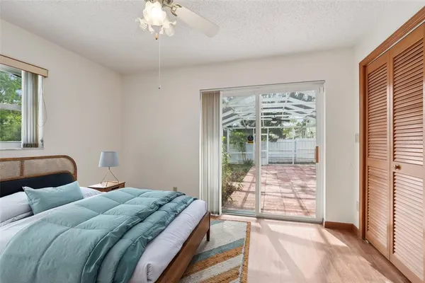 a bedroom with a large bed and a lamp next to a window
