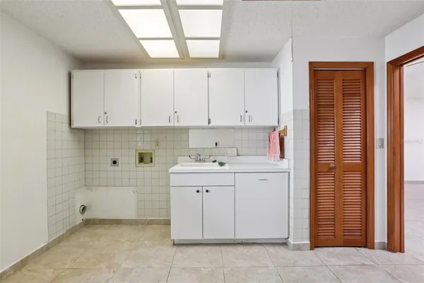 a room with a sink cabinets and utility room