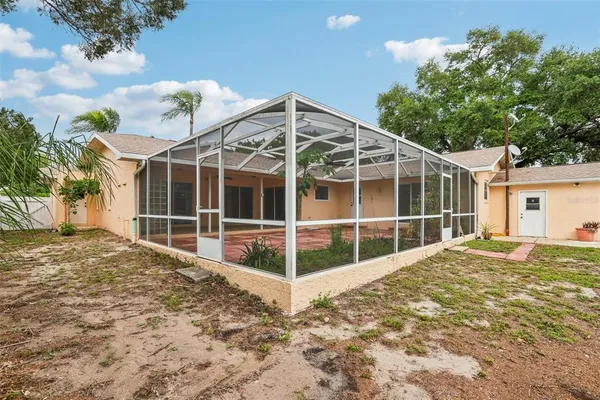 a view of a house with a window and wooden fence