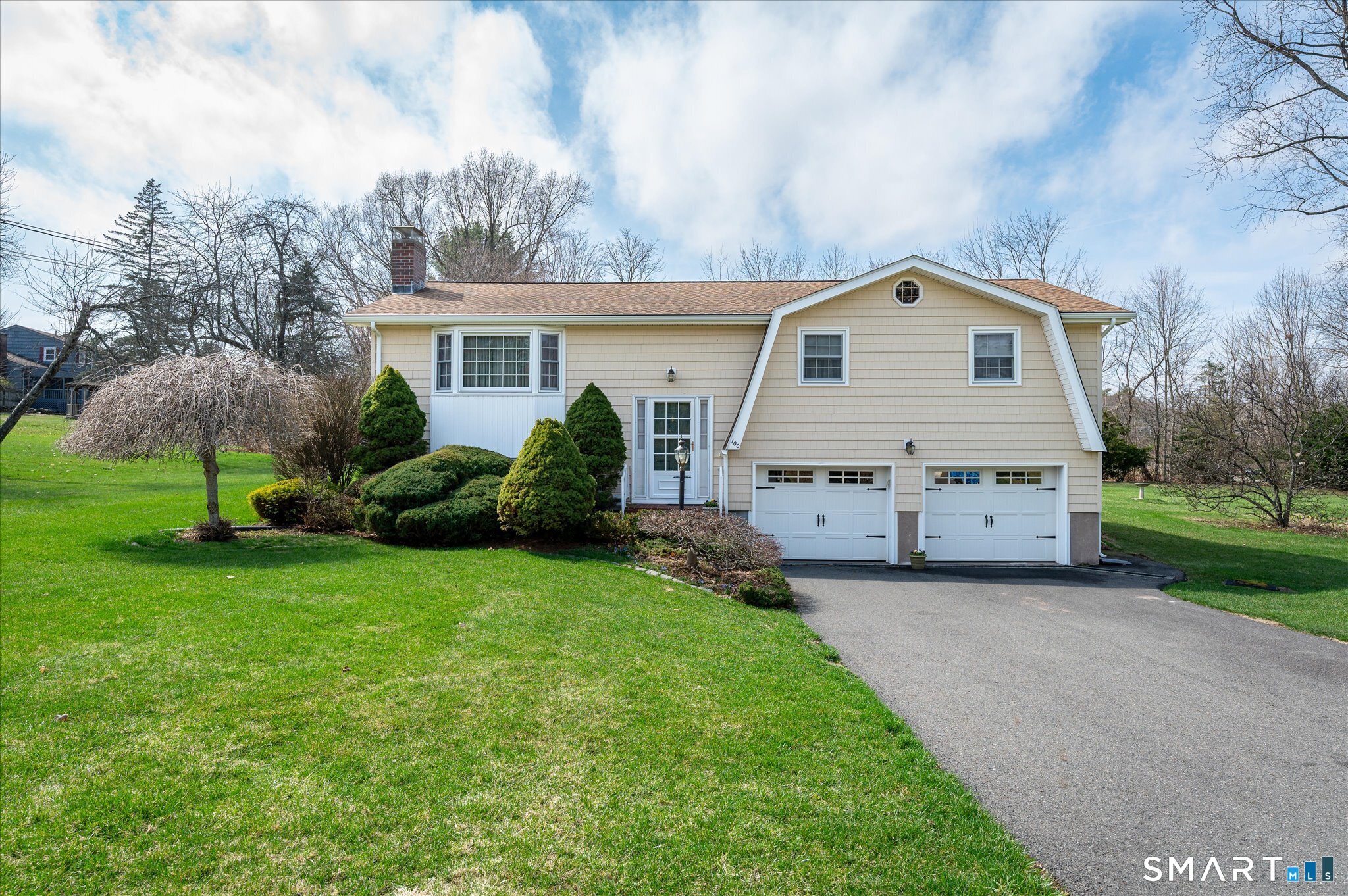 a front view of house with yard and green space