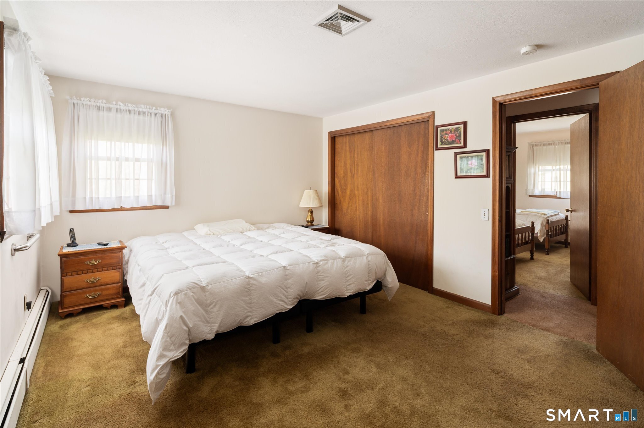 100 Bette Circle Vernon, CT 06066 - Photo 18 of 32 a bed sitting in a spacious bedroom next to a window