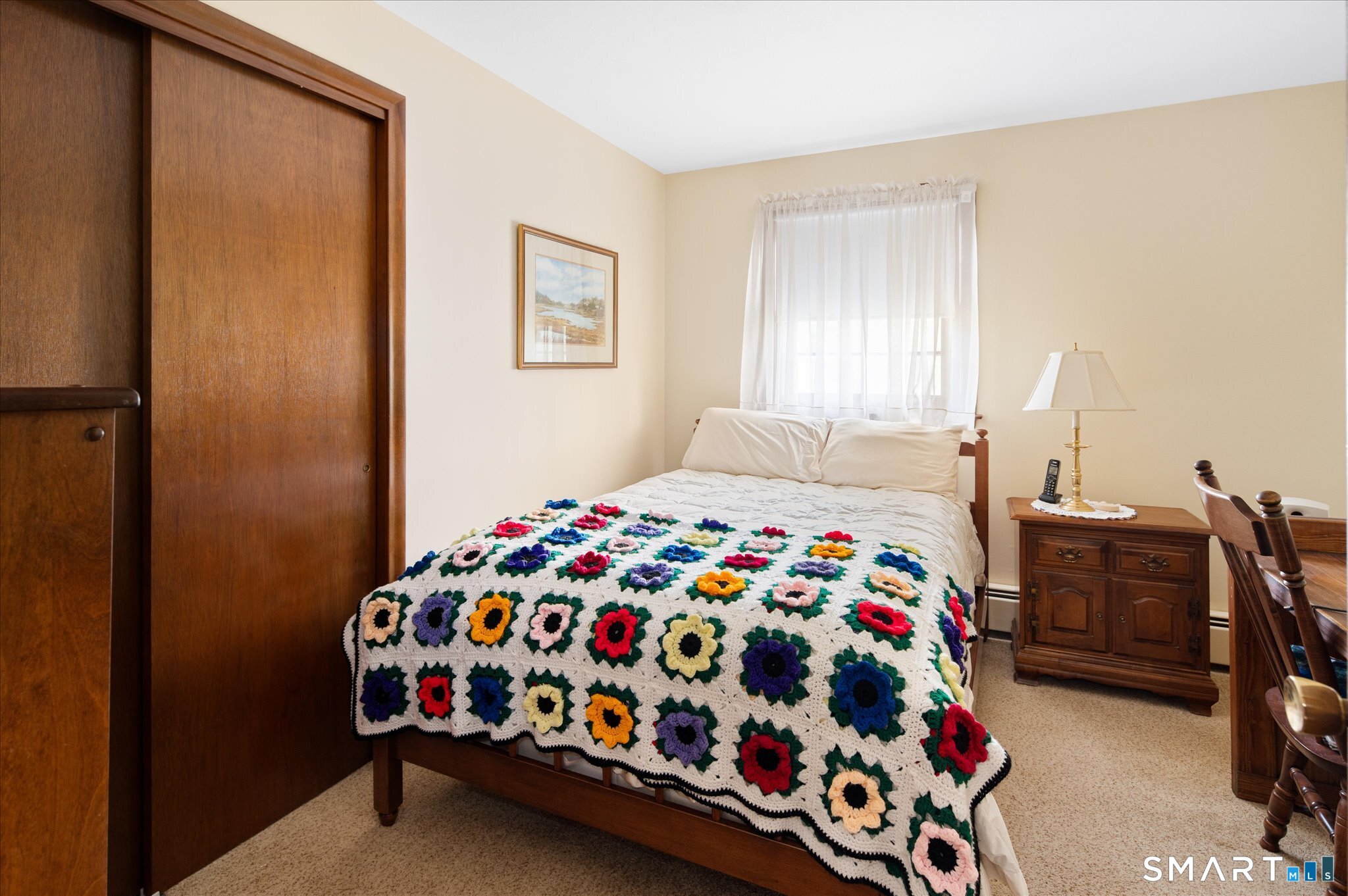 100 Bette Circle Vernon, CT 06066 - Photo 23 of 32 a bedroom with a bed and a lamp on dresser