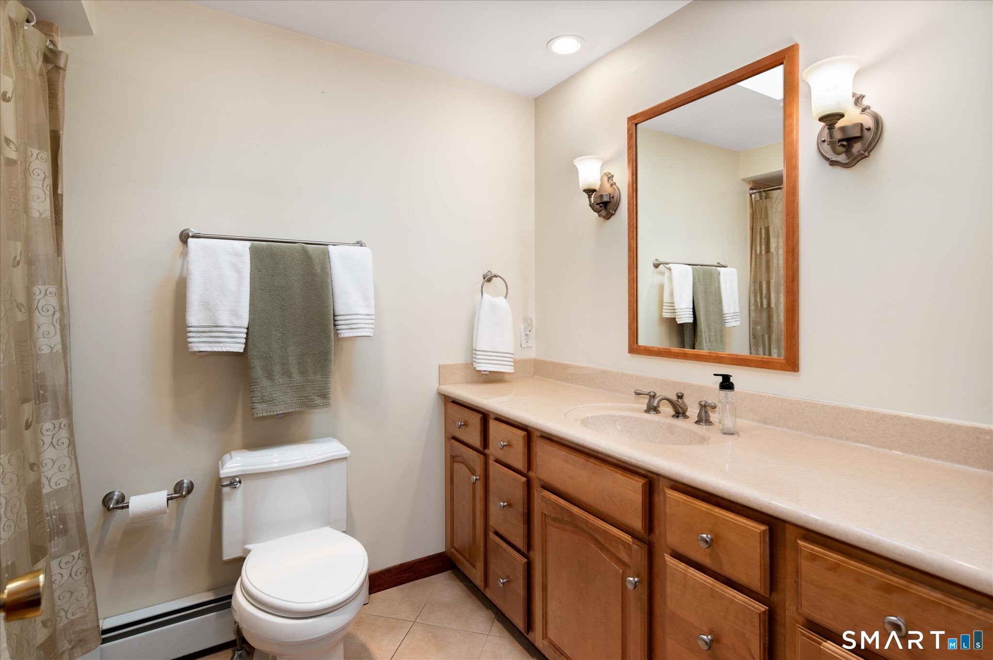 100 Bette Circle Vernon, CT 06066 - Photo 27 of 32 a bathroom with a double vanity sink toilet and mirror