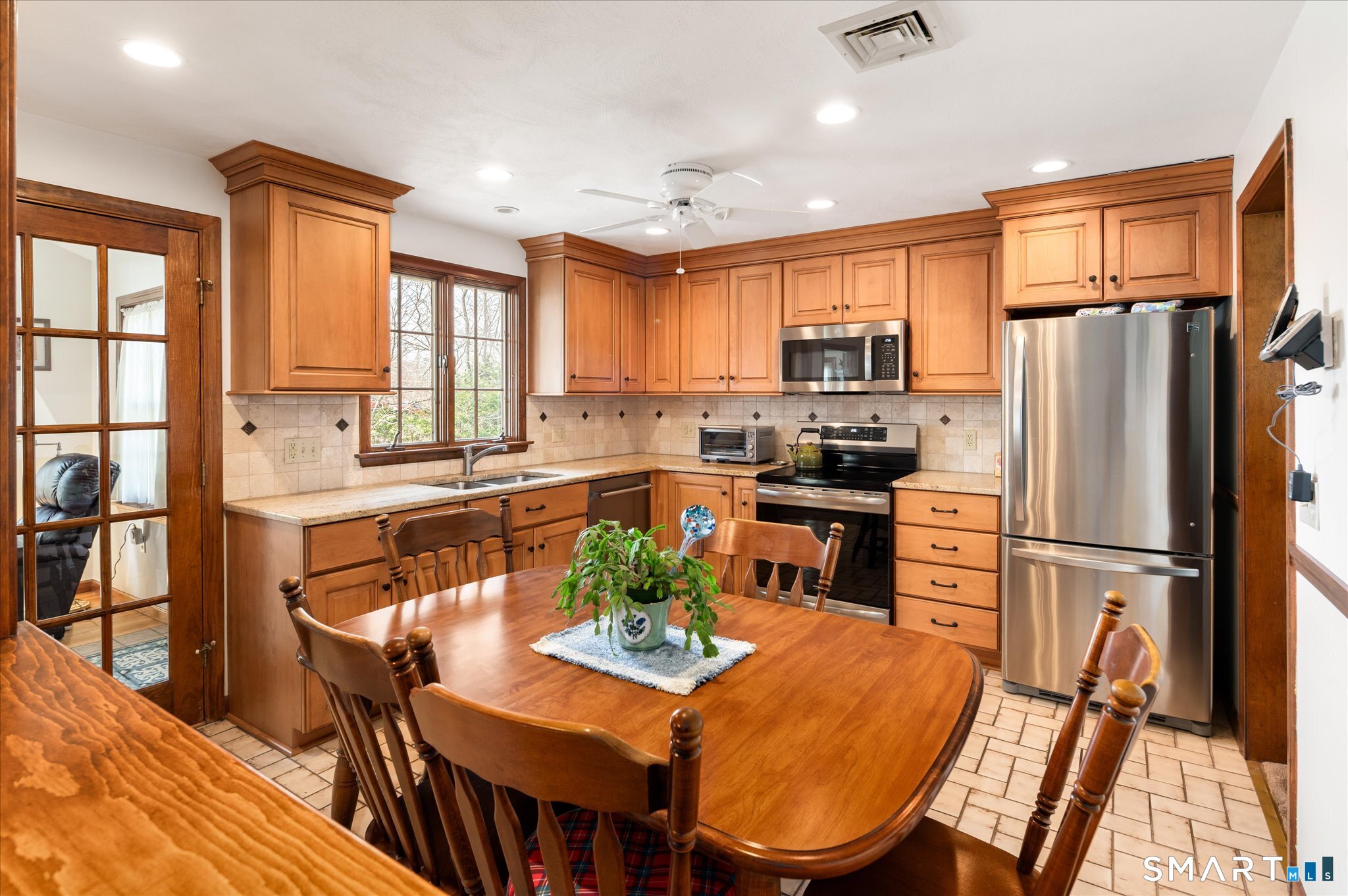100 Bette Circle Vernon, CT 06066 - Photo 6 of 32 a kitchen with stainless steel appliances granite countertop a refrigerator a stove a sink a dining table and chairs