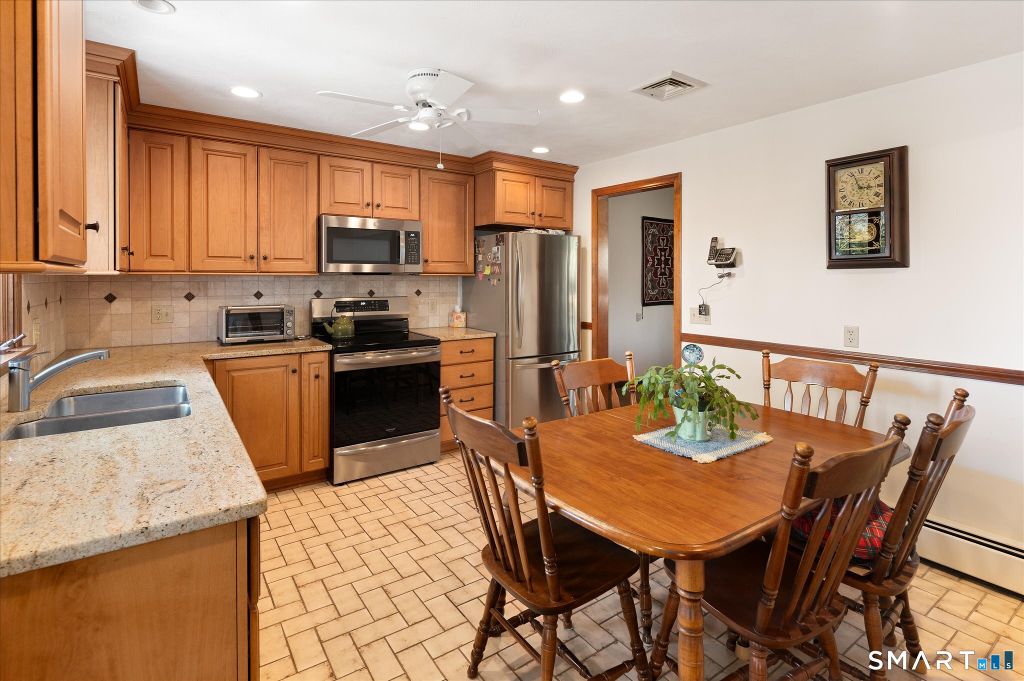 100 Bette Circle Vernon, CT 06066 - Photo 7 of 32 a kitchen with stainless steel appliances granite countertop a stove a refrigerator a sink a dining table and chairs