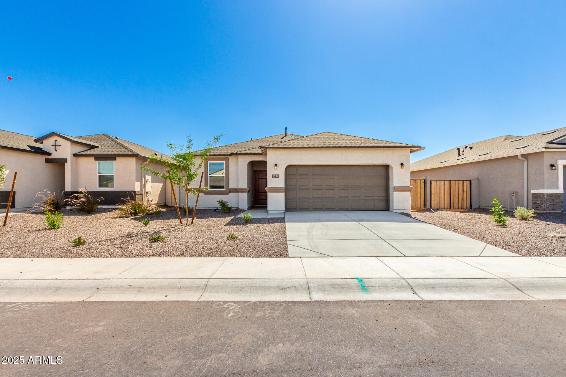 5507 East Mearn Road San Tan Valley, AZ 85140 - Photo 28 of 30 a front view of a house with a yard and garage