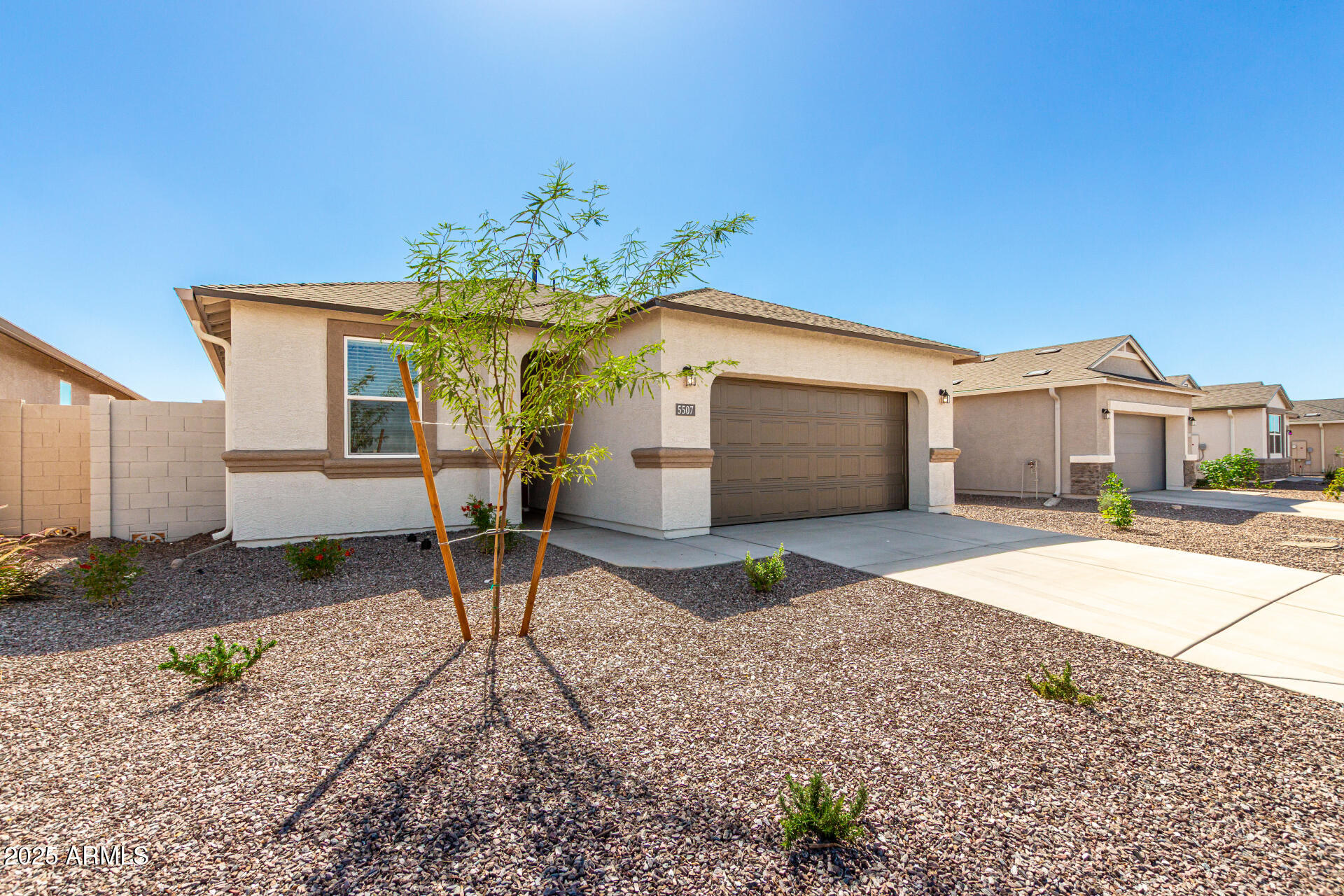 5507 East Mearn Road San Tan Valley, AZ 85140 - Photo 3 of 30 a front view of a house with a yard and garage