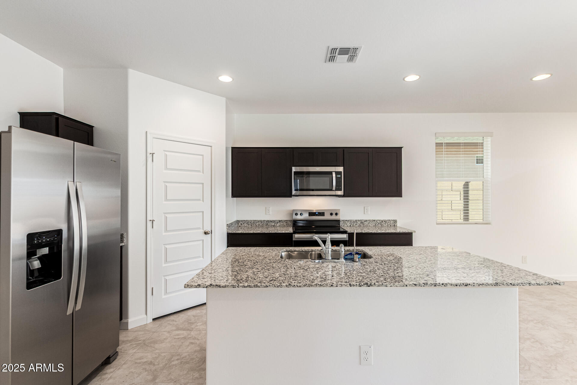 5507 East Mearn Road San Tan Valley, AZ 85140 - Photo 7 of 30 a kitchen with stainless steel appliances granite countertop a refrigerator and a stove top oven