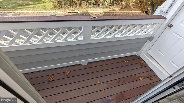 a view of a kitchen with wooden floor and a window