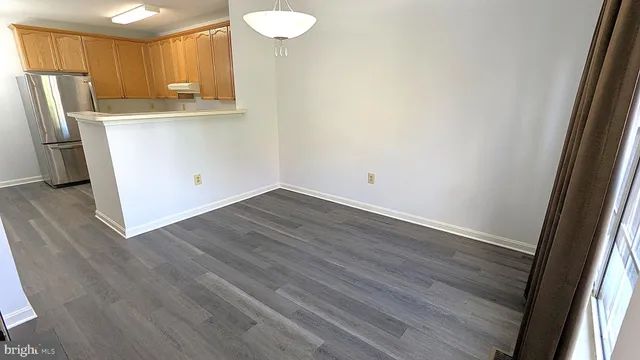 a view of a dining room with furniture wooden floor and a window