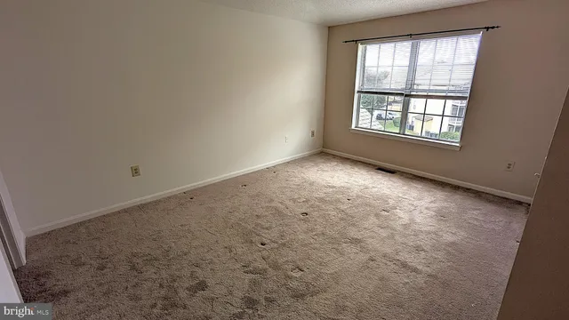 a bed room with a bed and a chair