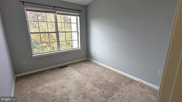 a bedroom with a bed chair and a window