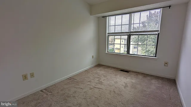 a bedroom with bed and window