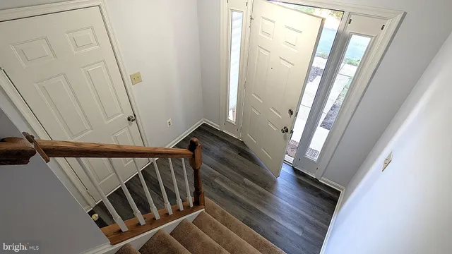 a view of entryway and hall with wooden floor