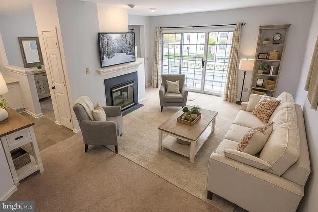 a view of a livingroom with wooden floor and a fireplace