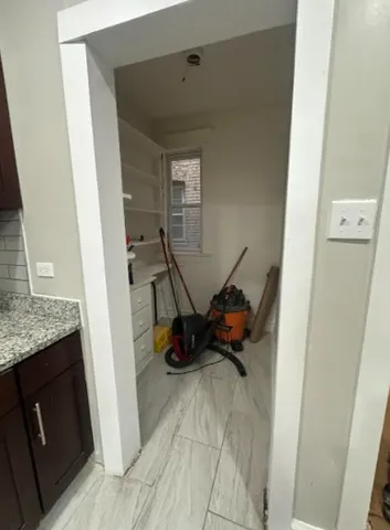 a view of storage and utility room with two washing machine