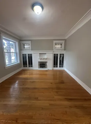 a living room with fireplace furniture and a window