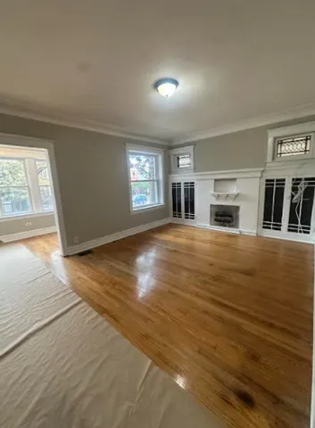 wooden floor in an empty room with a window