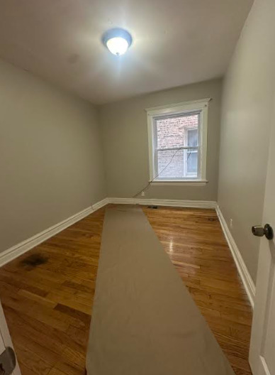 7704 South Aberdeen Street, Unit 1S Chicago, IL 60620 - Photo 5 of 14 an empty room with a window